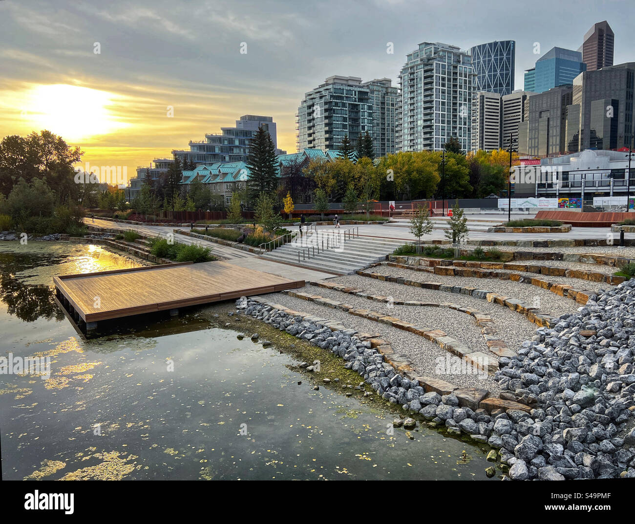 The lagoon at Eau Claire in downtown Calgary, Alberta, Canada, at sunrise in autumn. - Smartphone Captured Stock Image