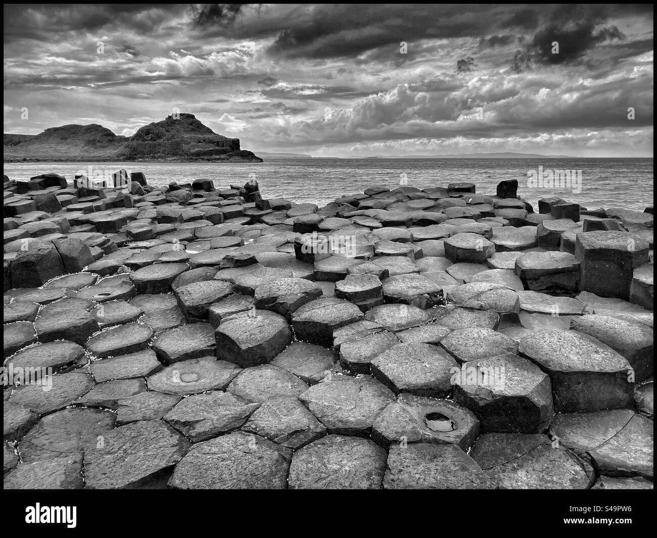 Hexagonal volcanic rock blocks that form the landscape at Giants Causeway in North Ireland. A sight of immense geographical importance as well as a tourist attraction. Photo ©️ COLIN HOSKINS. - Smartphone Captured Stock Image