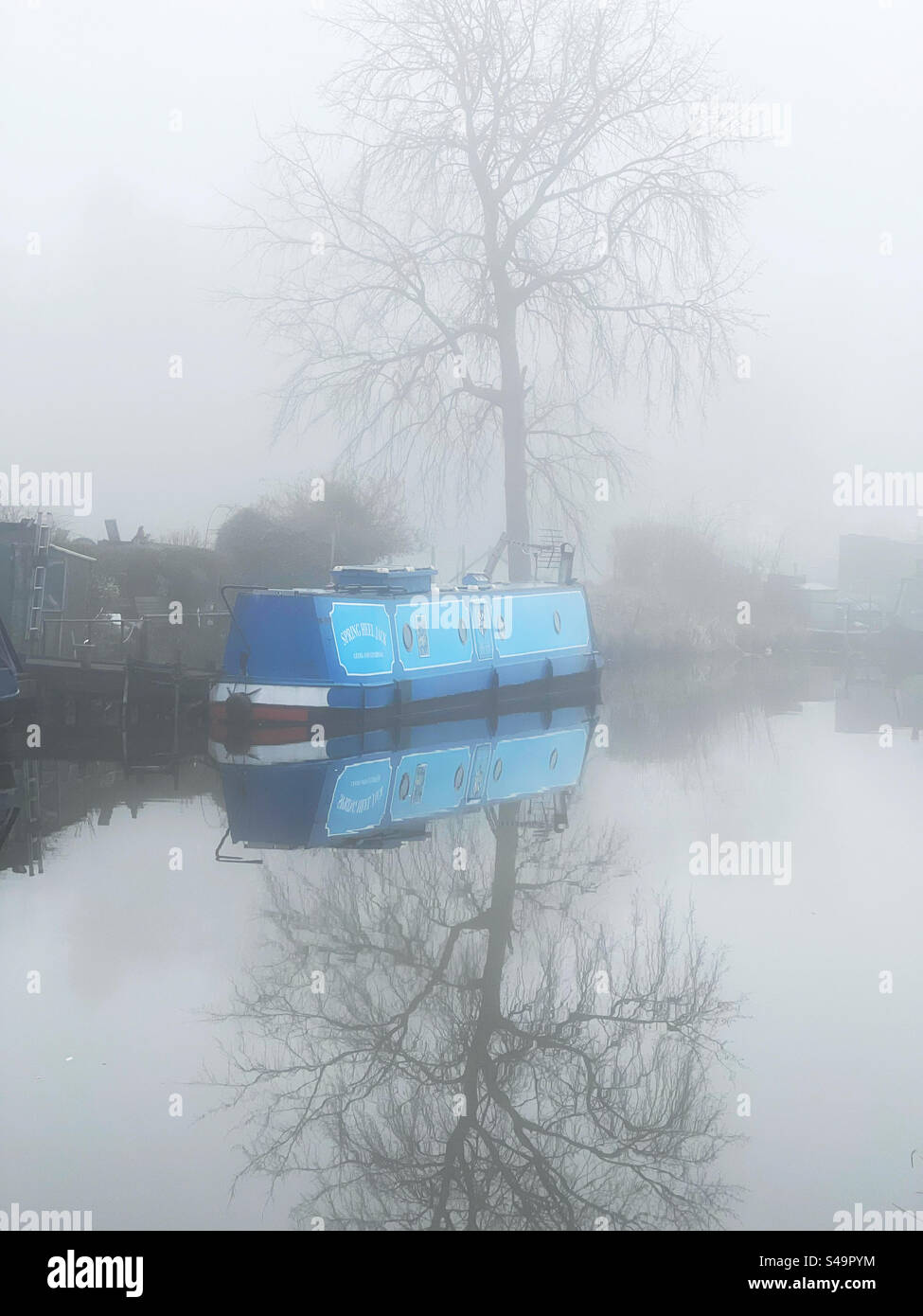 Narrow boat moored on a foggy morning on the Leeds and Liverpool canal at Adlington in Lancashire Stock Photo