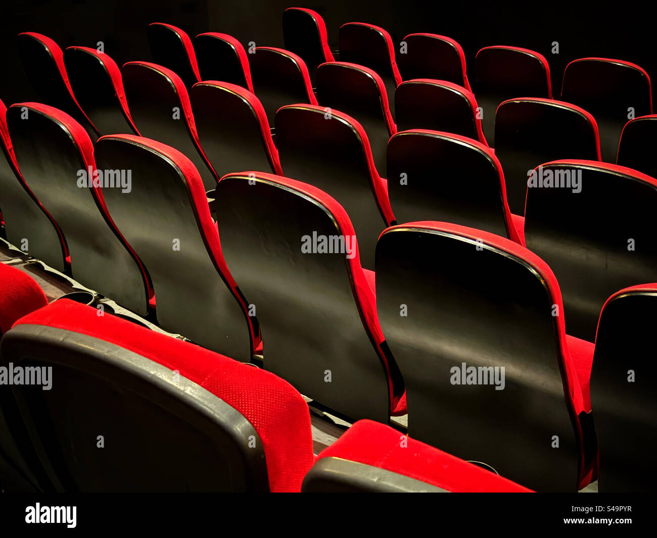 The graphic shapes of rows of cinema seats in an auditorium. The show has not started and the audience is still to take their seats. The performance beckons….. Photo ©️ COLIN HOSKINS. - Smartphone Captured Stock Image
