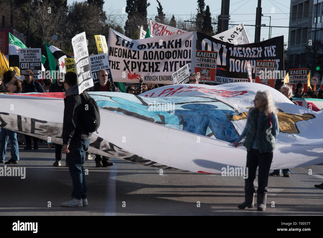 Athens, Greece. 16th March 2019. Migrants and refugees hold placards and shout slogans against racism and closed borders as well as against the greek neo-Nazi party Golden Dawn, currently on trial with accusations such as criminal organization, murder, possession of weapons and racist violence. Leftist and anti-racist organizations staged a rally on the occasion of the International Day against racism to demonstrate against discrimination and racist policies and behaviours. © Nikolas Georgiou / Alamy Live News Stock Photo