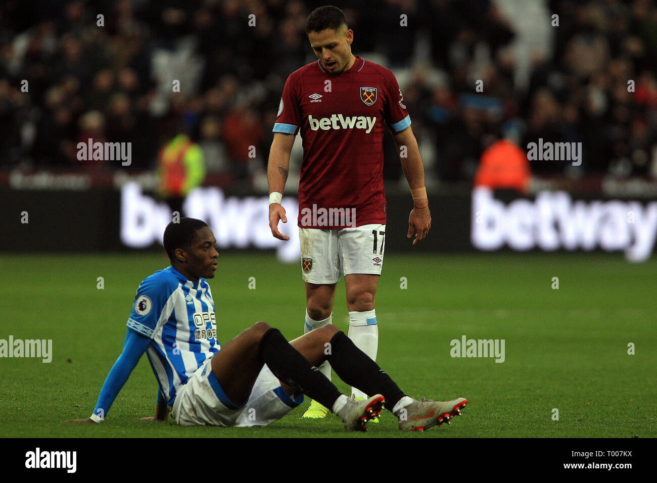 London, UK. 16th March 2019. Javier Hernandez of West Ham United (R) consoles Terence Kongolo of Huddersfield Town (L) after the game. Premier League match, West Ham United v Huddersfield Town at the London Stadium, Queen Elizabeth Olympic Park in London on Saturday 16th March 2019.  this image may only be used for Editorial purposes. Editorial use only, license required for commercial use. No use in betting, games or a single club/league/player publications . pic by Steffan Bowen/Andrew Orchard sports photography/Alamy Live news Credit: Andrew Orchard sports photography/Alamy Live News Stock Photo