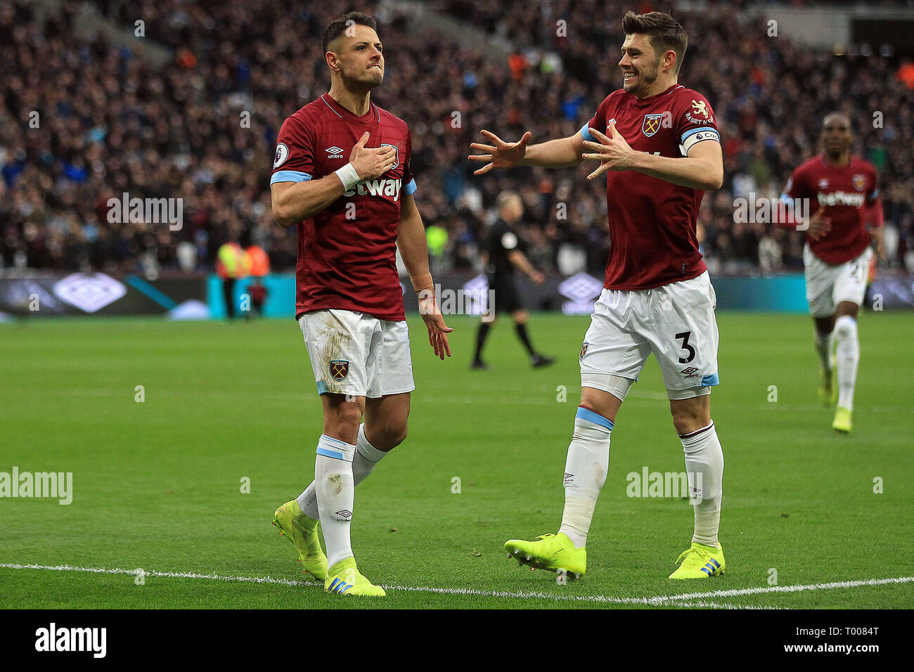 London, UK. 16th March 2019.Javier Hernandez of West Ham United (L) celebrates after scoring his team's third goal. Premier League match, West Ham United v Huddersfield Town at the London Stadium, Queen Elizabeth Olympic Park in London on Saturday 16th March 2019.  this image may only be used for Editorial purposes. Editorial use only, license required for commercial use. No use in betting, games or a single club/league/player publications . pic by Steffan Bowen/Andrew Orchard sports photography/Alamy Live news Stock Photo
