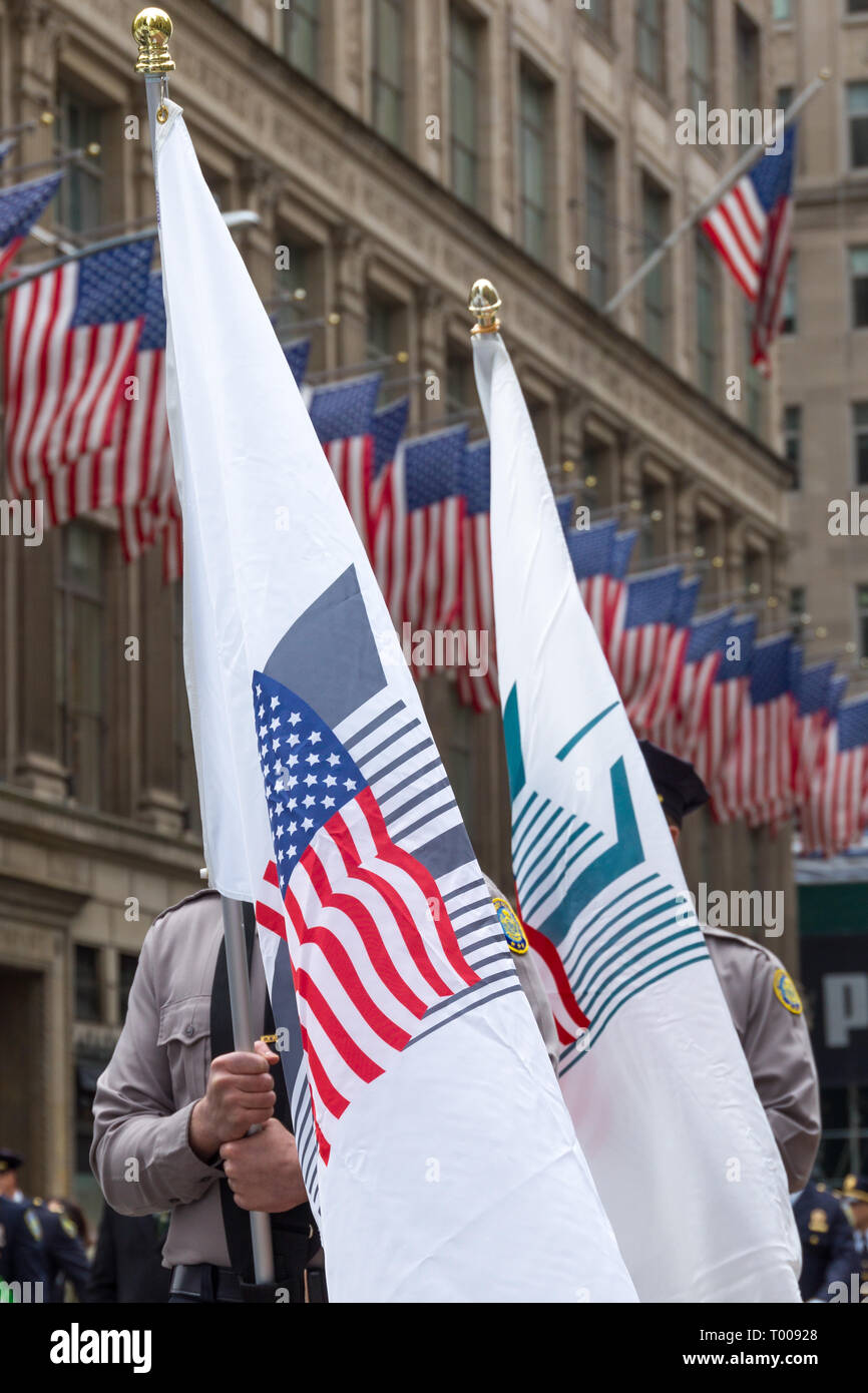 New York, USA. 16 March 2019.  Members of the New York Police department carry flags with symbols of the Twin Towers as they march through New York's 5th Avenue during the 258th NYC St. Patrick's Day Parade.  Photo by Enrique Shore Credit: Enrique Shore/Alamy Live News Stock Photo