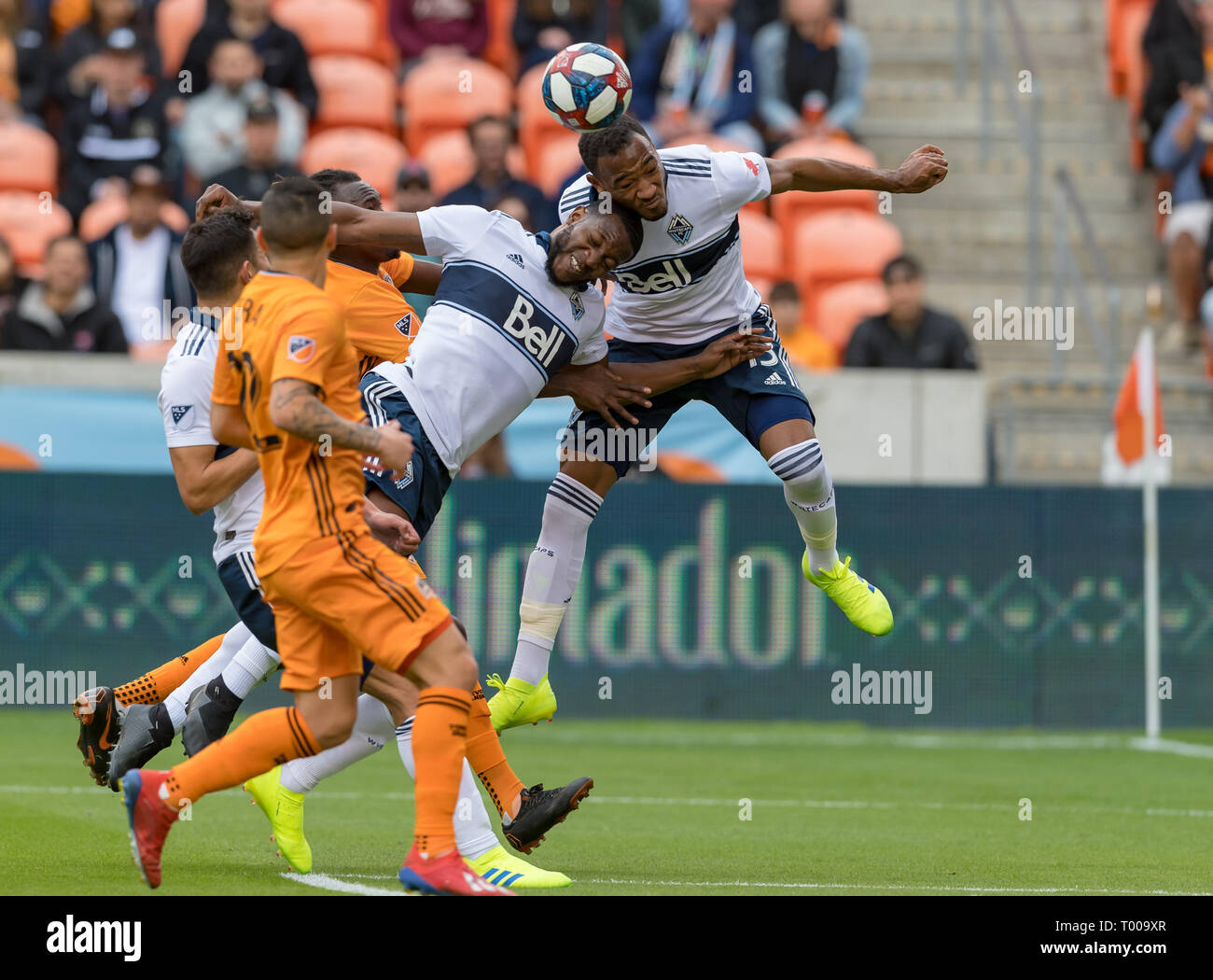 Compass Stadium, Houston, Texas, USA. March 16, 2019: Vancouver Whitecaps defender Derek Cornelius (13) and forward Alhassane Bangoura (19) go up for the header in front of the goal during the match between the Vancouver Whitecaps FC and the Houston Dynamo at BBVA Compass Stadium in Houston, Texas The score at the half Dynamo is in the lead 2-1 © Maria Lysaker/CSM. Stock Photo