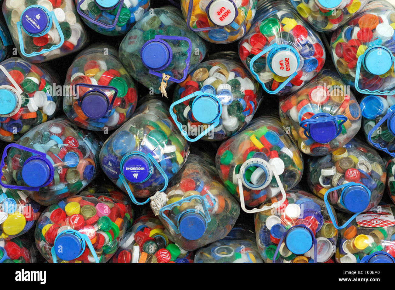 Colored Plastic Covers in Plastic Bottles in the Factory on Processing