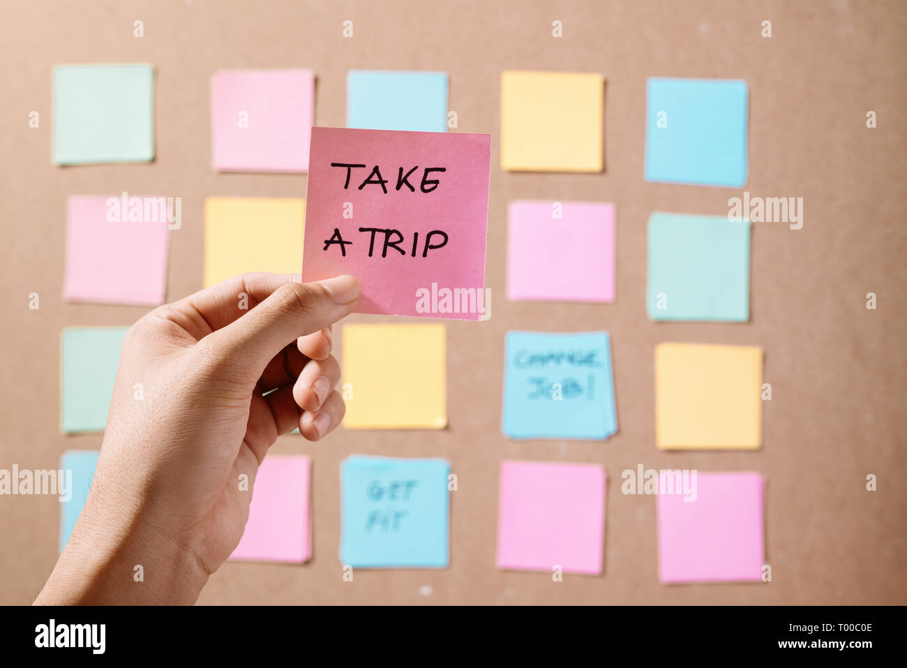 Motivational word 'Take a trip' on pink card Stock Photo