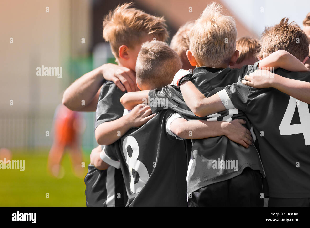 Junior Football Team Stacking Hands Before School Tournament Match ...