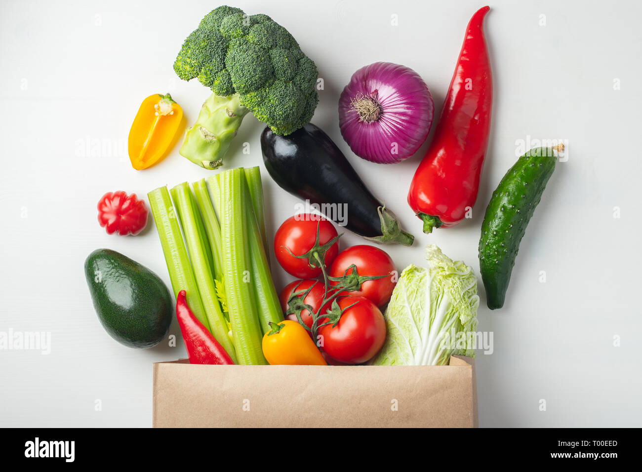 Paper bag with fresh vegetables on white background. Flat lay. Top view ...