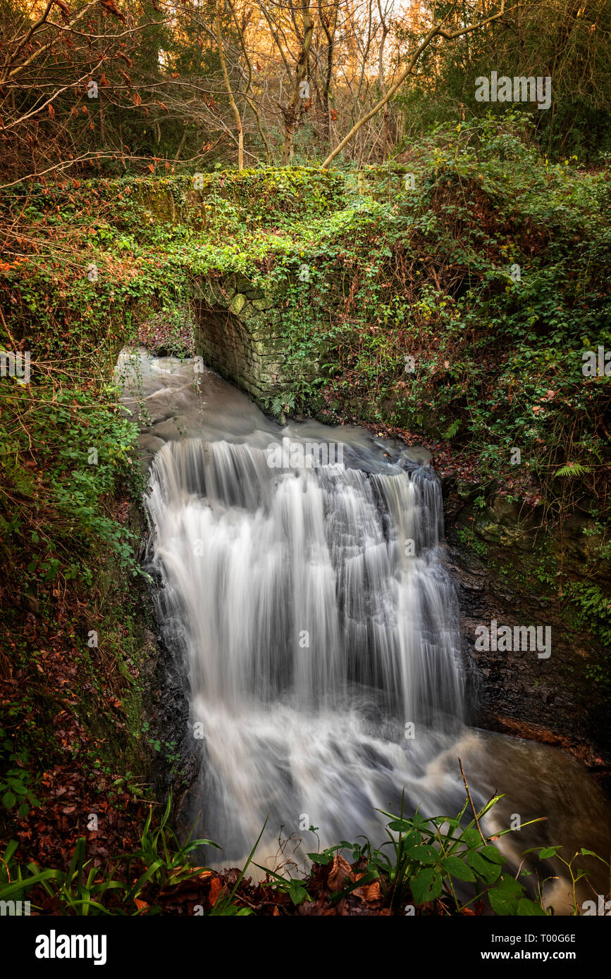 Waterfall passing under a bridge at Small Water County Durham Stock Photo