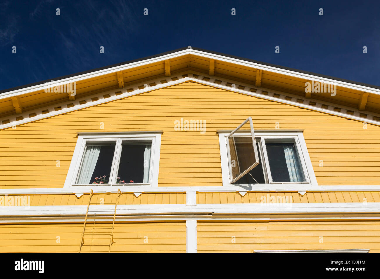 White windows on exterior side wall of a yellow two story house, Porvoo, Finland, Europe Stock