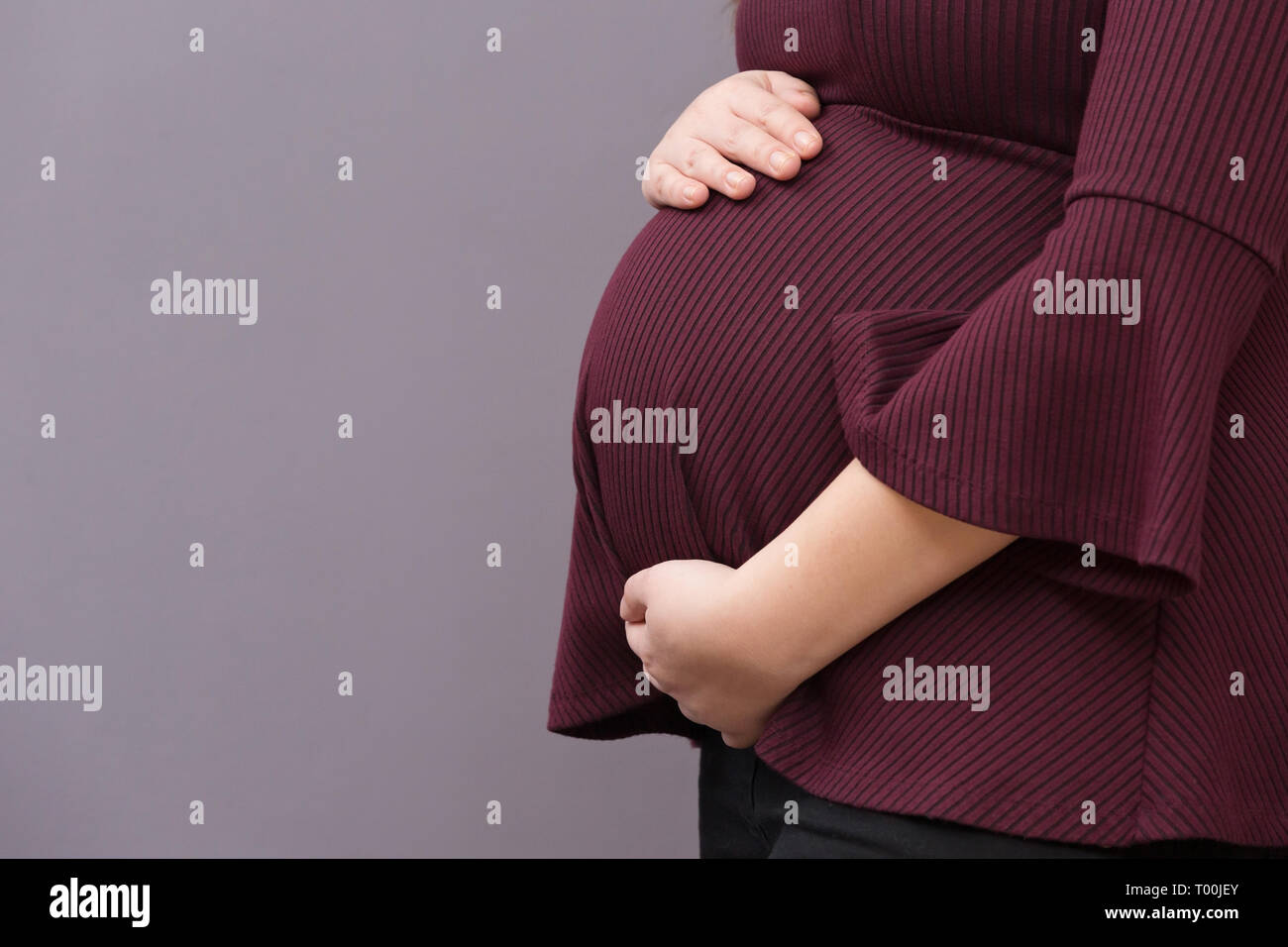 Close-up of pregnant mother lovingly holding her unborn child Stock Photo