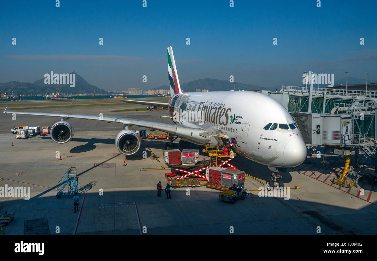 An Emirates Airbus A380-800 airliner viewed from the boarding gate window, Hong Kong Airport. Stock Photo