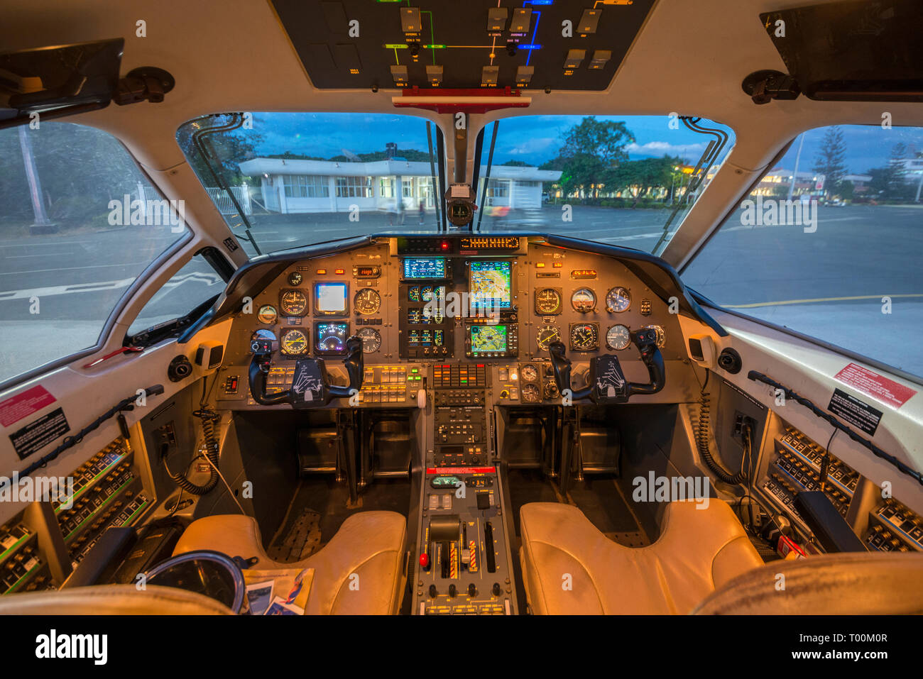 Dusk lighting, illuminates the flight deck of a Pilatus PC12 turboprop aircraft. Stock Photo