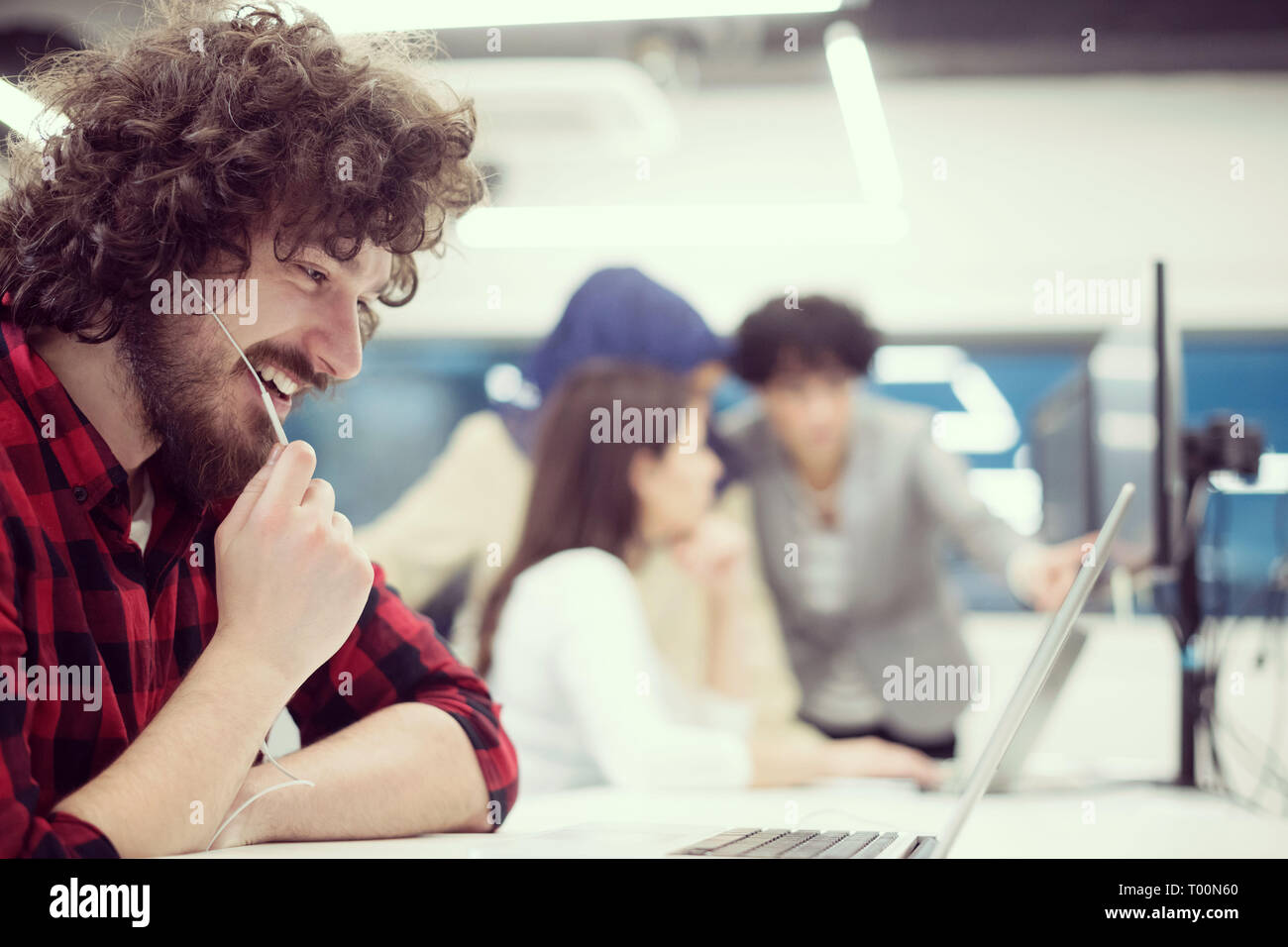 young multiethnics business team of software developers working together using laptop and desktop computer while writing programming code at modern st Stock Photo