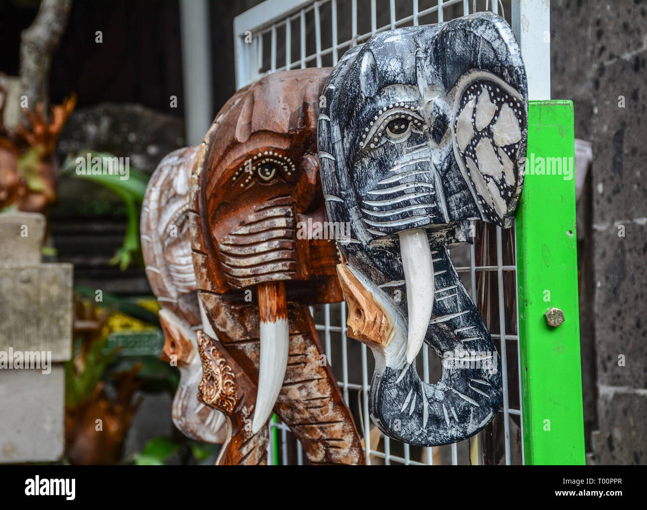 Lots of carved wooden elephants for sale at souvenir shop Stock Photo