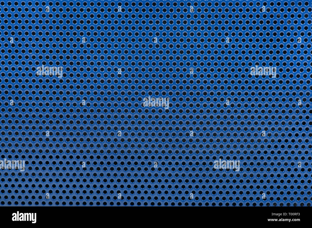 Blue background of metal mesh in the hole close-up Stock Photo