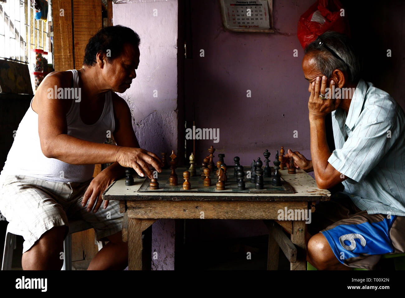 ANTIPOLO CITY, PHILIPPINES - MARCH 11, 2019: Filipino men relax and play a  game of chess inside their restaurant Stock Photo - Alamy