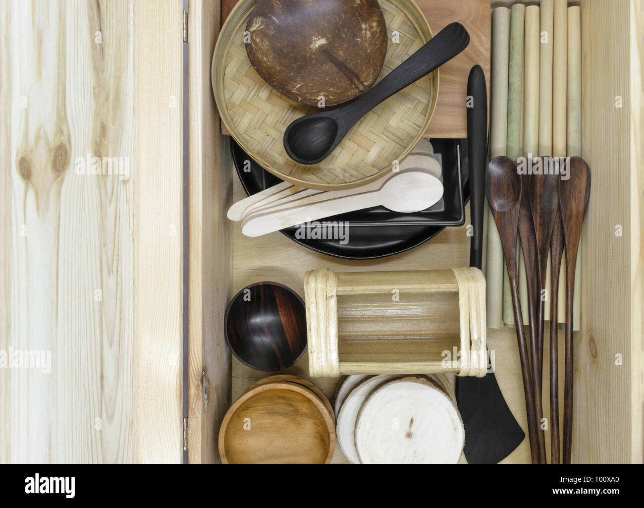 Set of various exotic wooden tableware in wooden box. Set consists