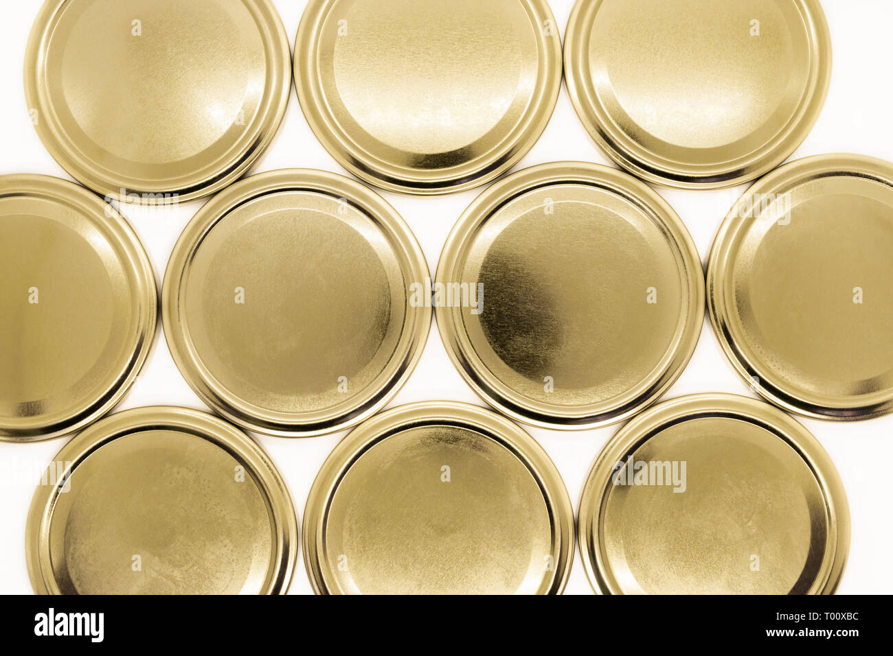 Golden jar lids on white background Stock Photo - Alamy