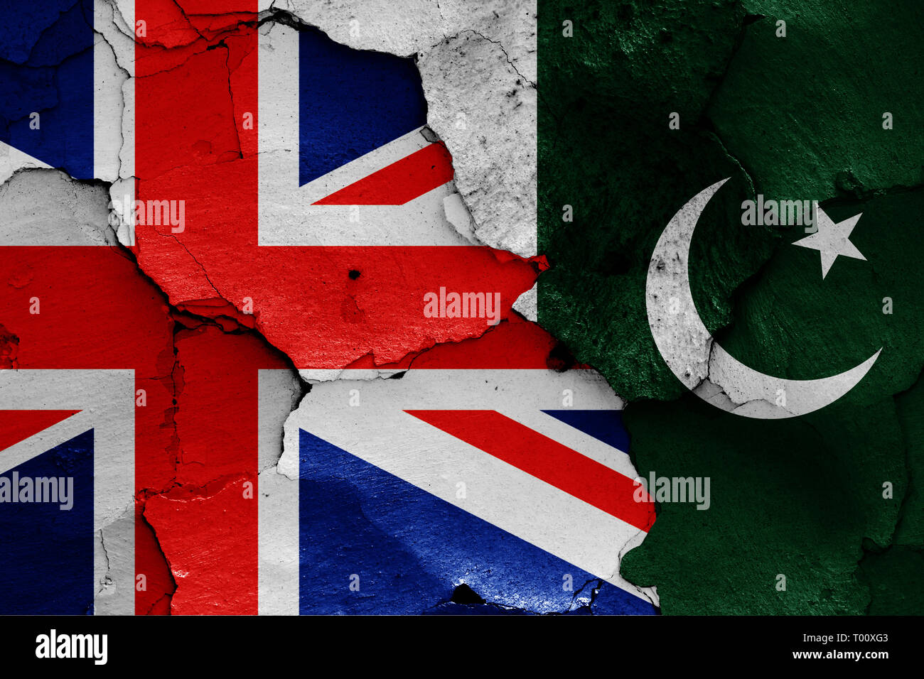 flags of UK and Pakistan painted on cracked wall Stock Photo