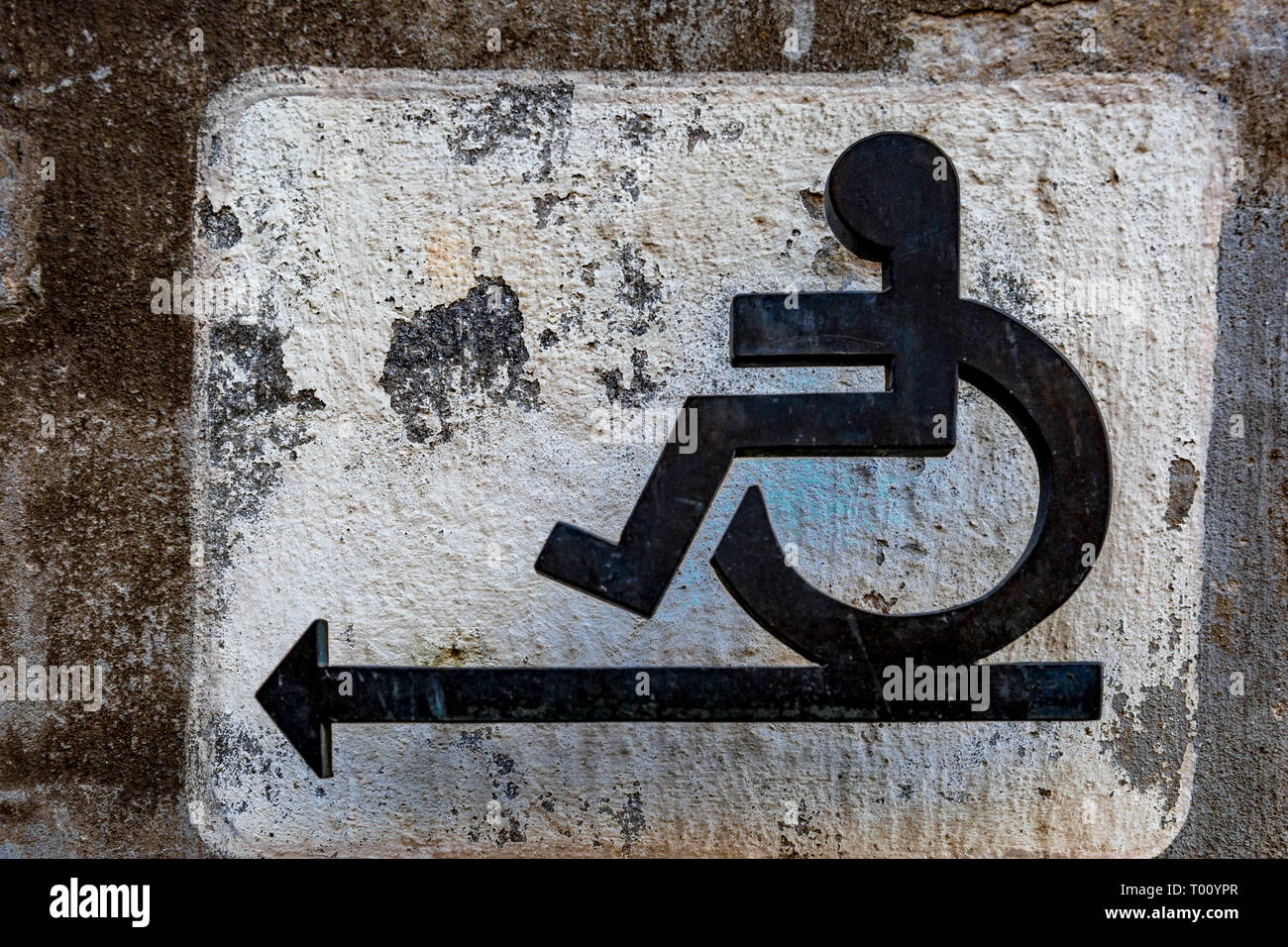 Icon wheelchair user with an arrow to the left Stock Photo