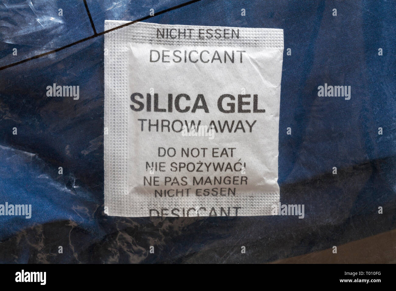 Sachet of silica gel inside polythene bag with clothing desiccant