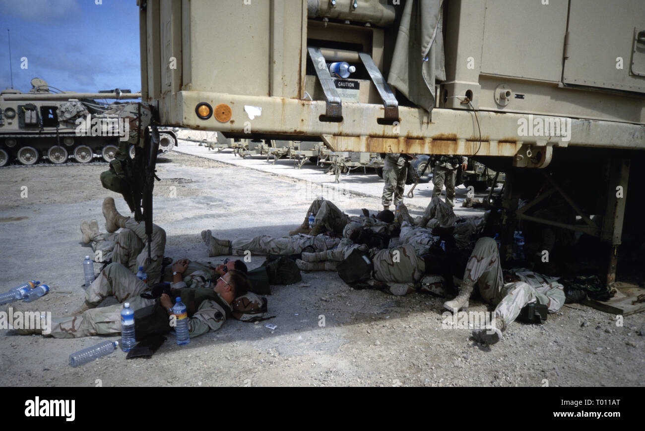 29th October 1993 U.S. Army soldiers of the 1st Armored Division rest in the shade after having just arrived by ship in Mogadishu's new port in Somalia. Stock Photo
