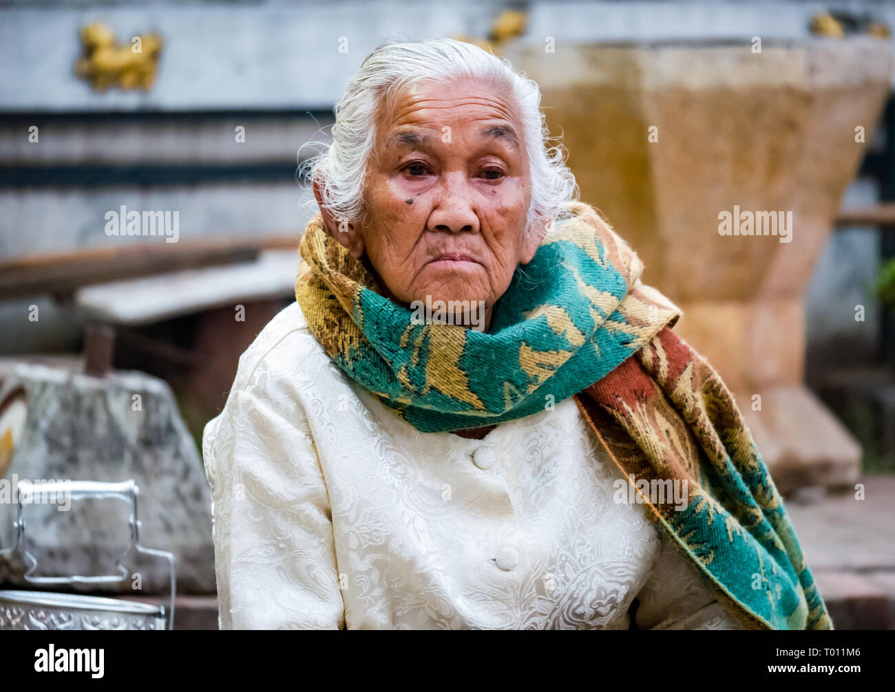 Old woman waiting to give rice in morning alms giving ceremony, Luang Prabang, Laos Stock Photo