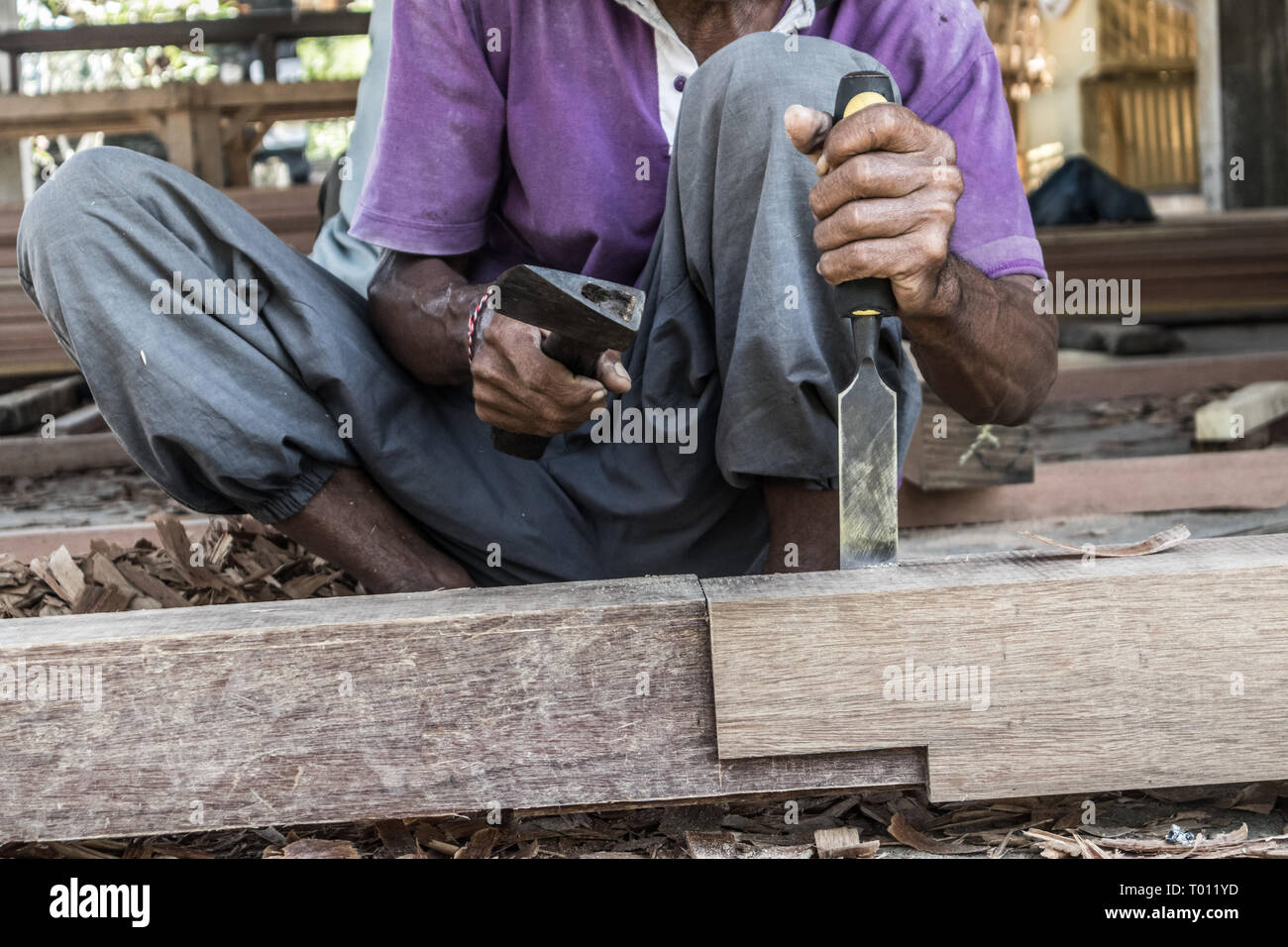 Close up of warn hands of carpenter working in traditional manual carpentry shop in a third world country. Stock Photo