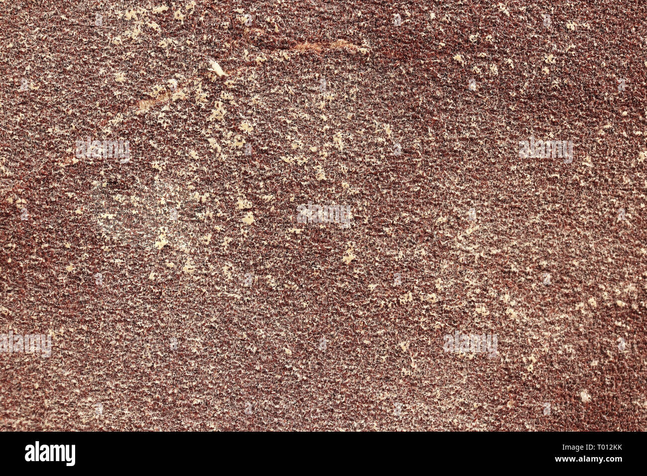 Burgundy Sandpaper Texture. Rough Grit Abrasive Background. Used Grain Emery Backdrop. Stock Photo