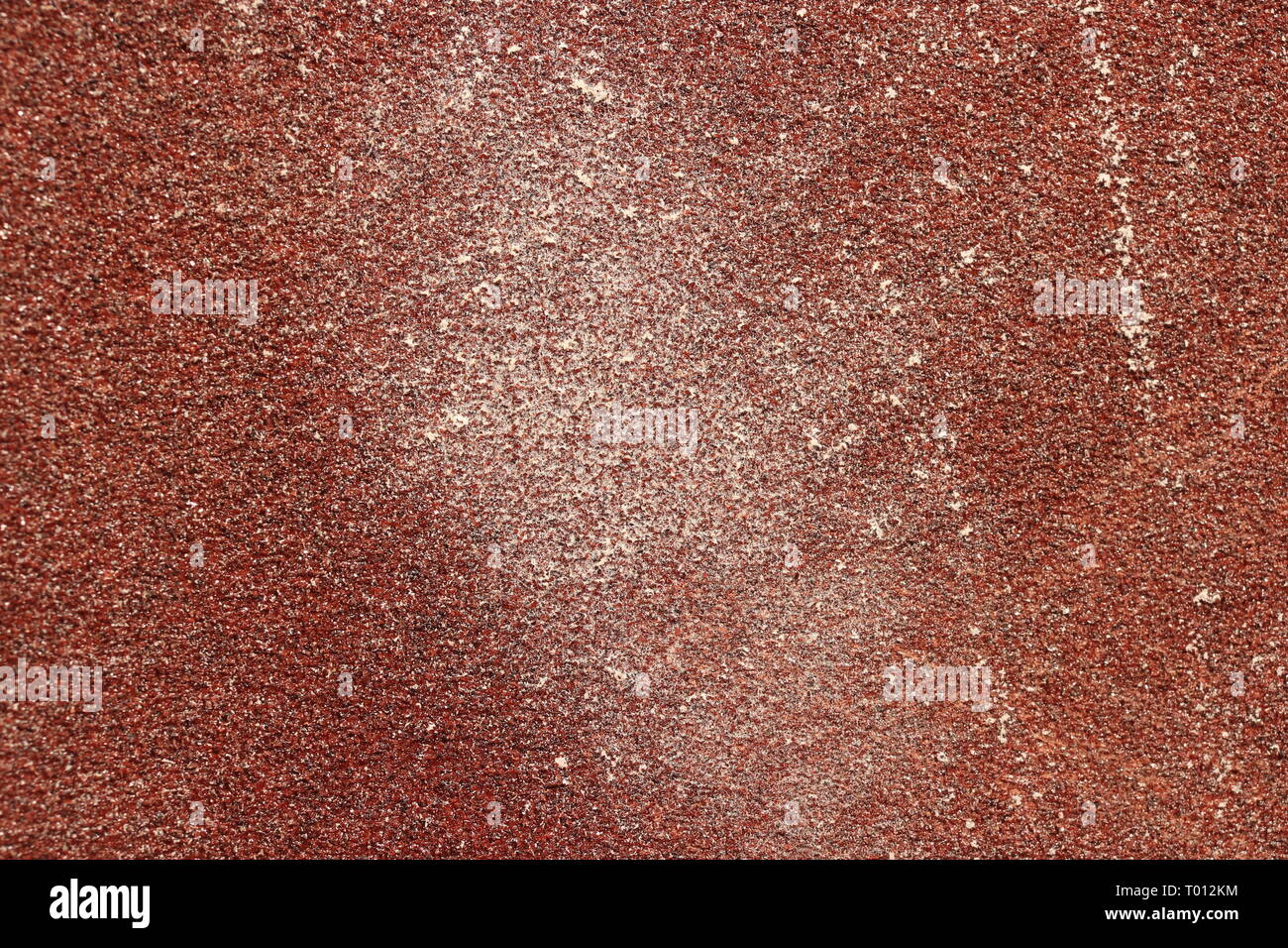 Red Sandpaper Texture. Rough Grit Abrasive Background. Used Grain Emery