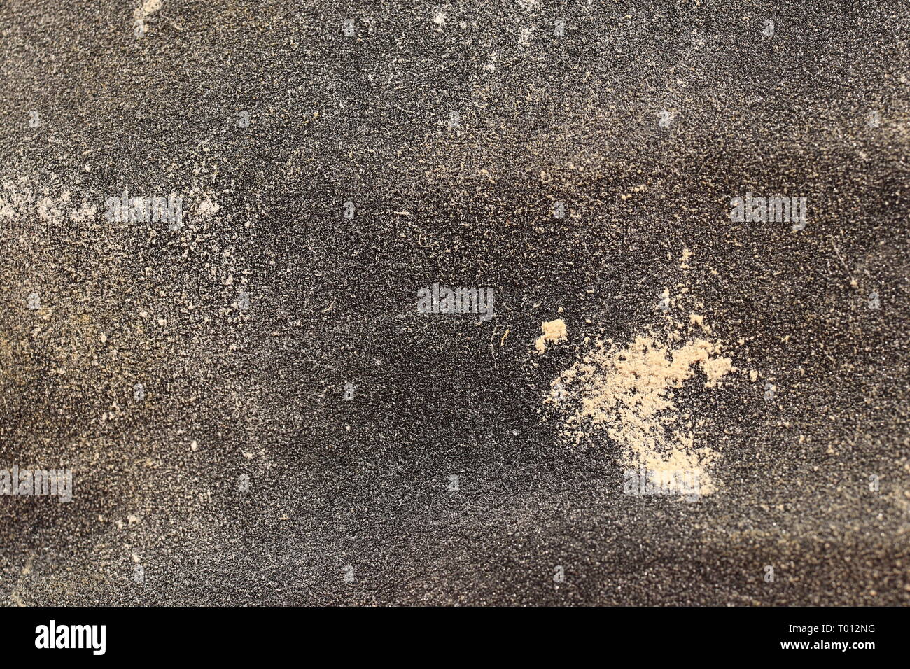 Black Sandpaper Texture with Wood Attrition. Rough Grit Abrasive Background. Used Grain Emery