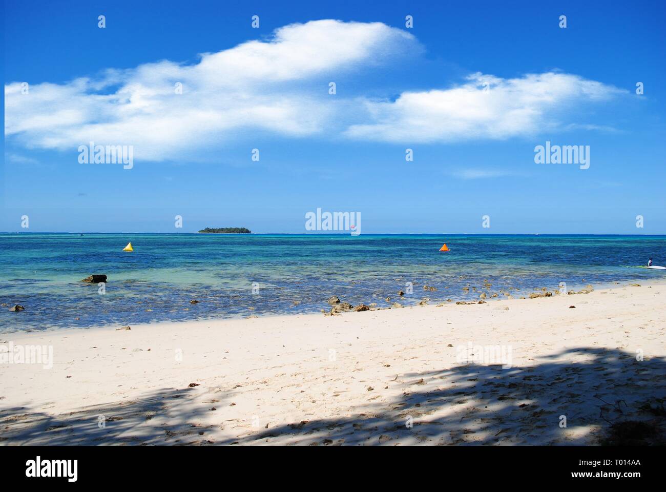 Low tide at Micro Beach, with Managaha Island in the distance Stock Photo