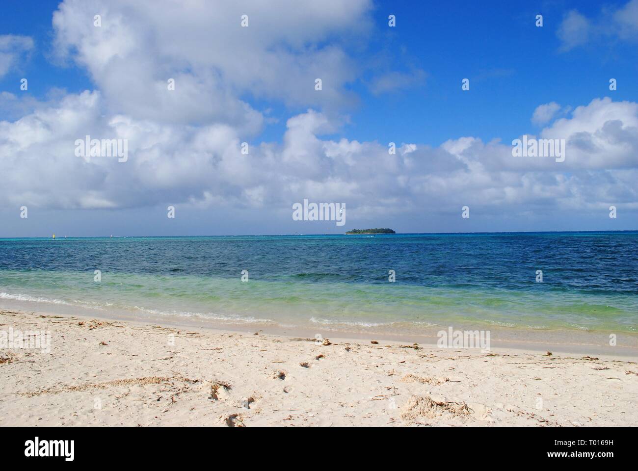 Micro Beach in Garapan, Saipan with its soft white sand, pristine blue waters and the Managaha Island in the distance. Stock Photo