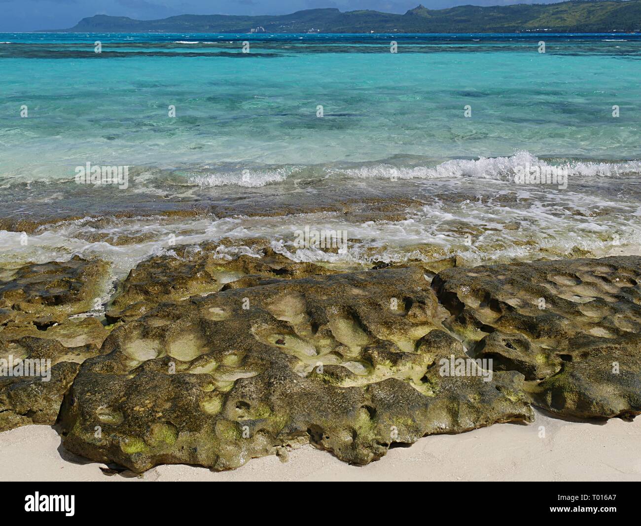 Beautiful rocks and corals line up at the beach in Managaha Island Stock Photo