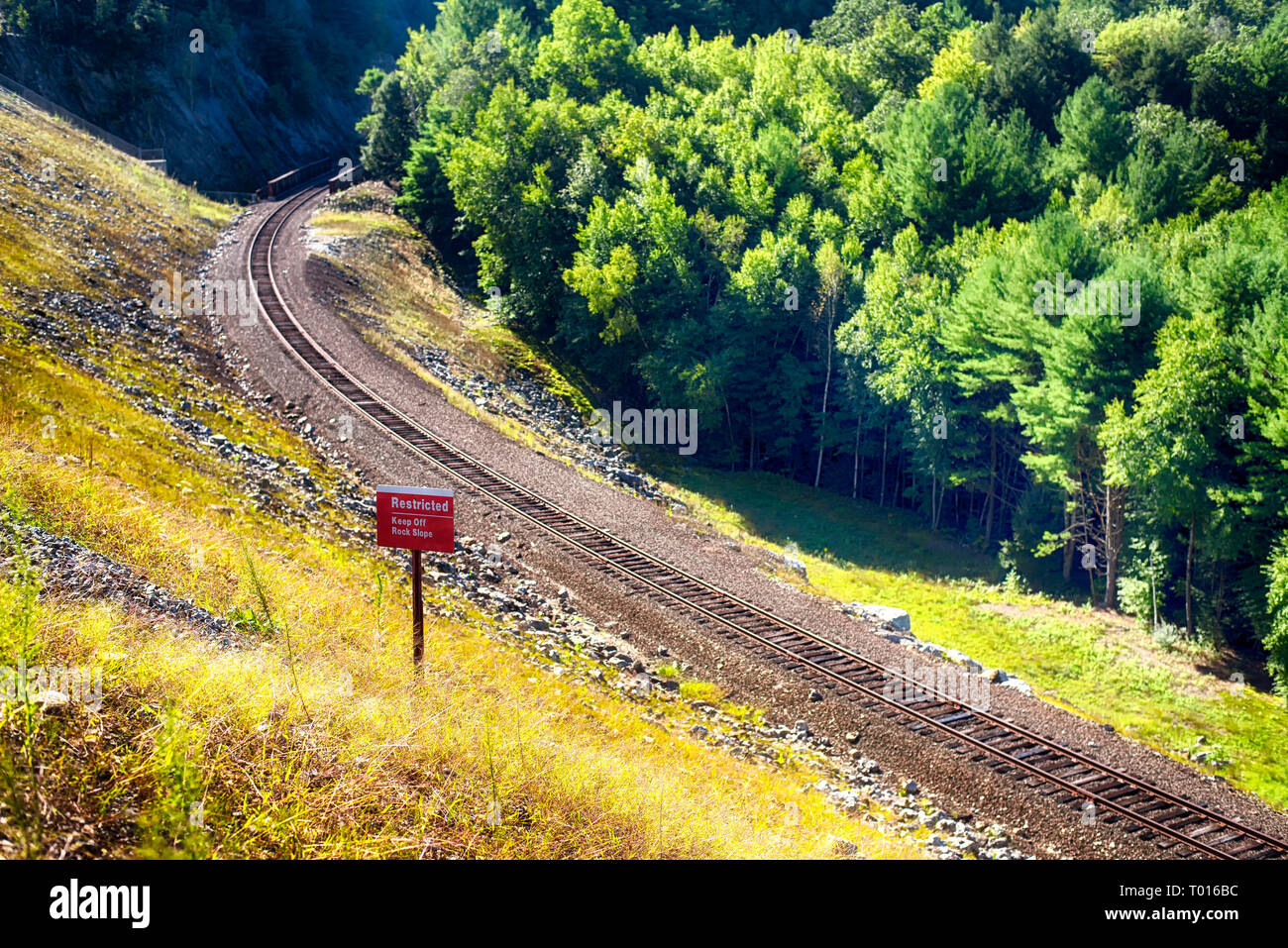 A railroad track laid on the side of the Thomaston Dam in Thomaston Connecticut on a sunny day. Stock Photo