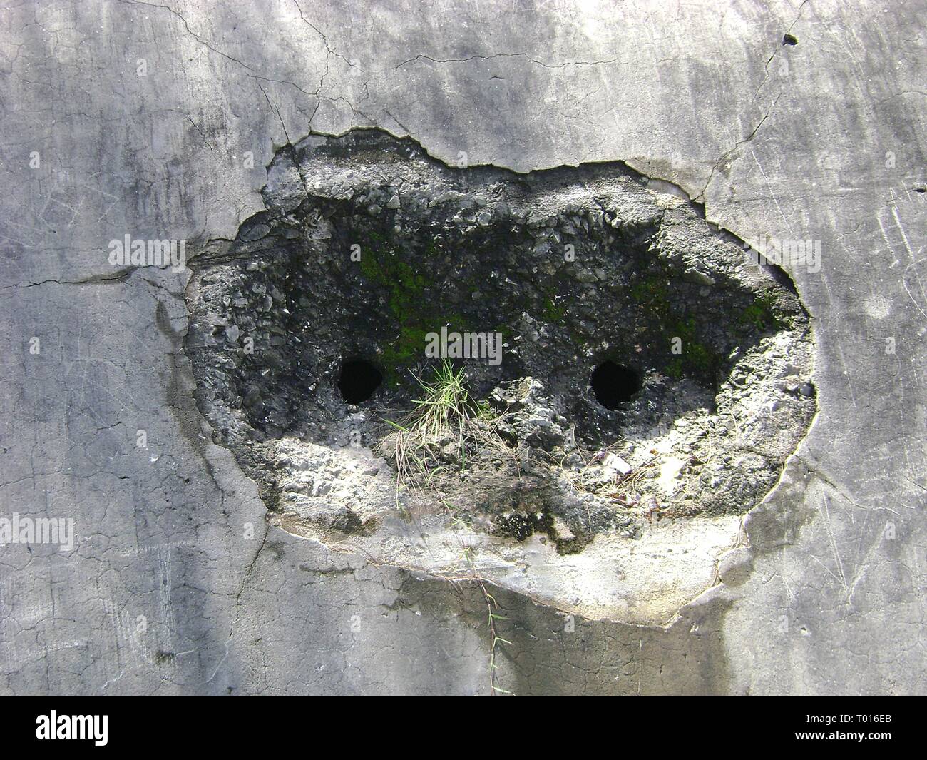 Bullet holes that went through at an air raid shelter near the Saipan International Airport from the World War 11 between Japanese and US. Stock Photo