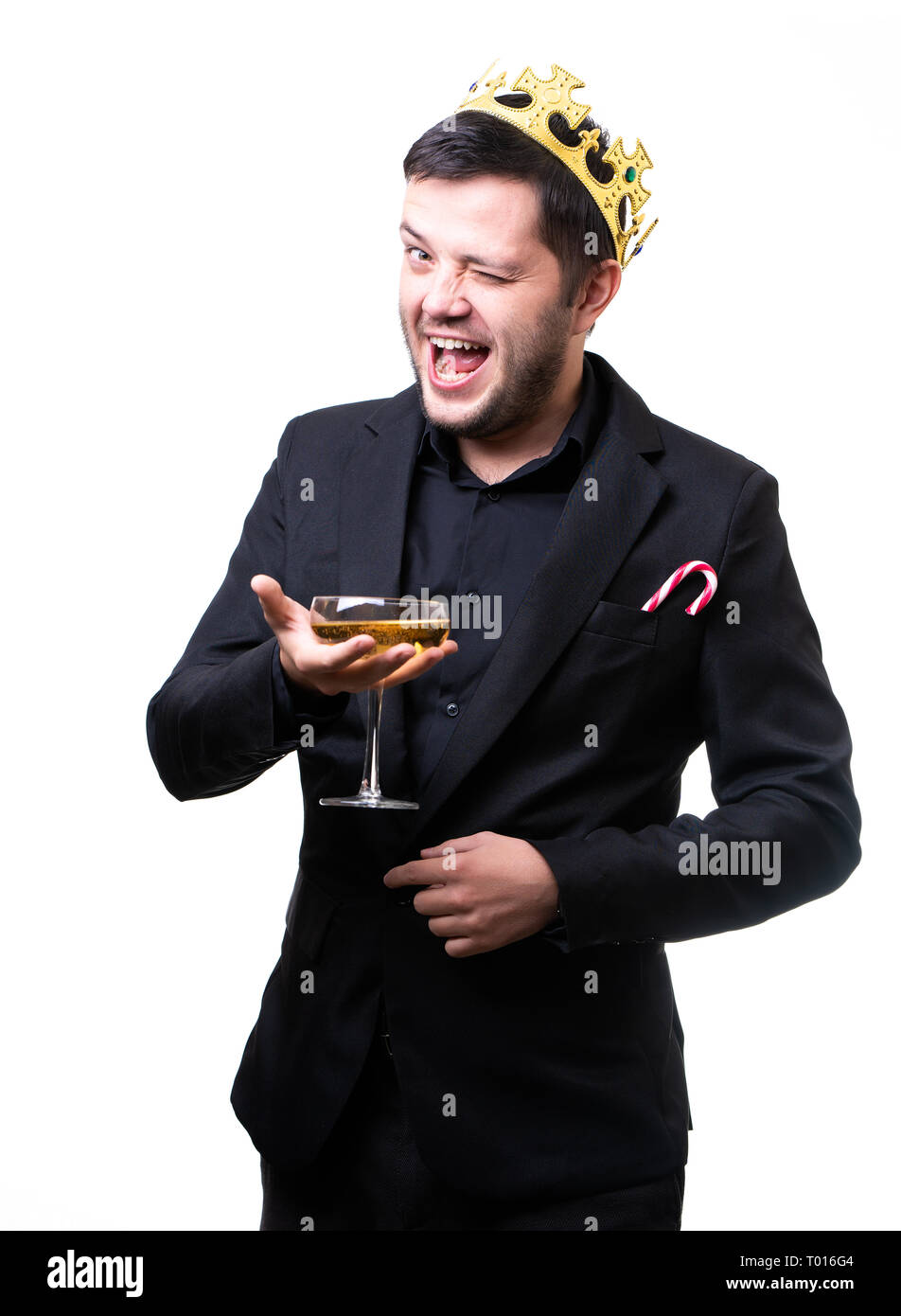 Man in crown, black suit with wine glass in hand . Stock Photo