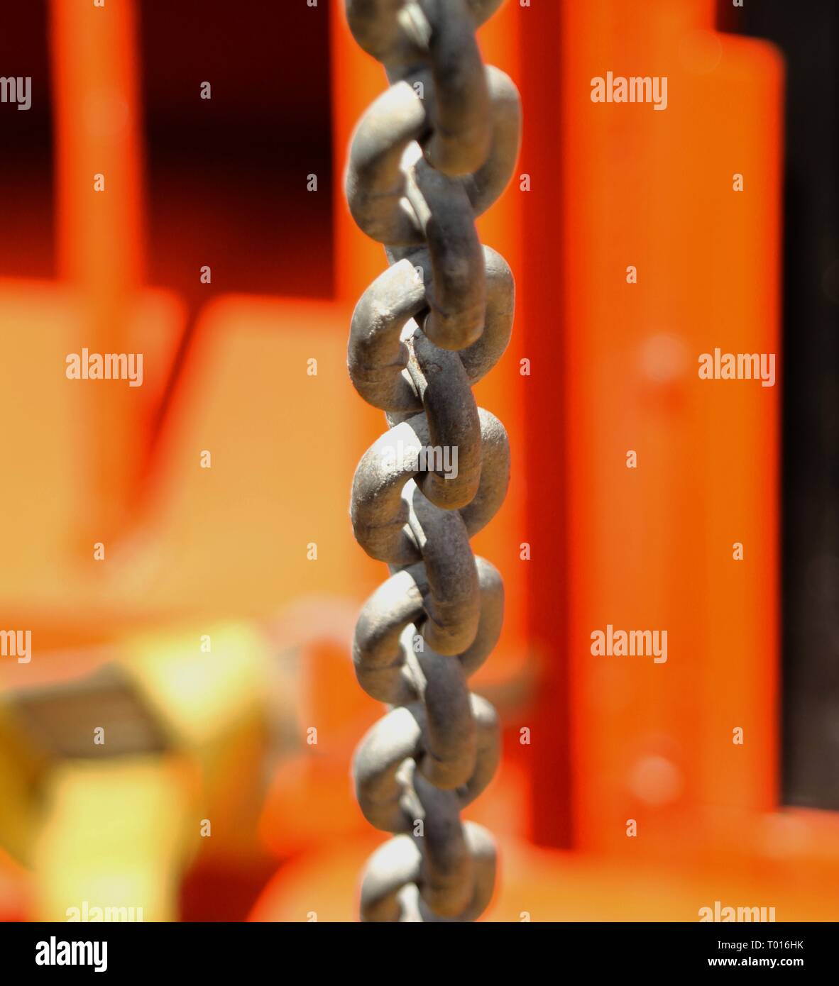 Thick chain hanging from high beam Stock Photo