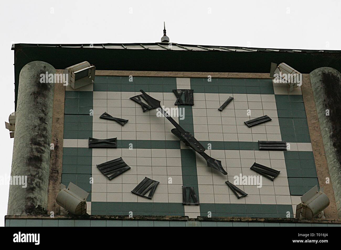 An old tower clock with Roman numerals stops at 5:55 o’clock Stock ...