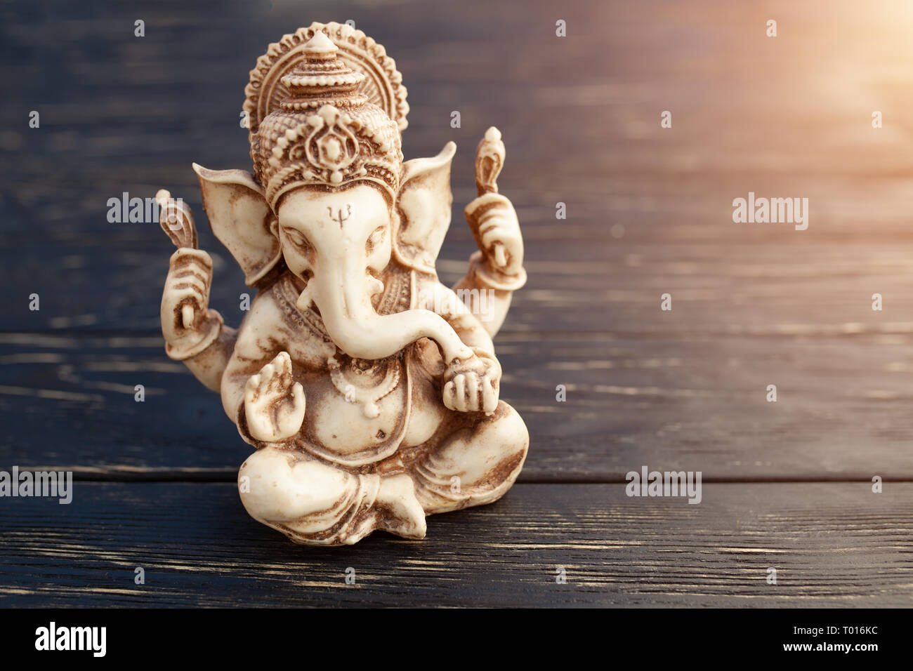 Hindu god Ganesh on black wooden background. Statue on table close up with  copy space for text Stock Photo - Alamy