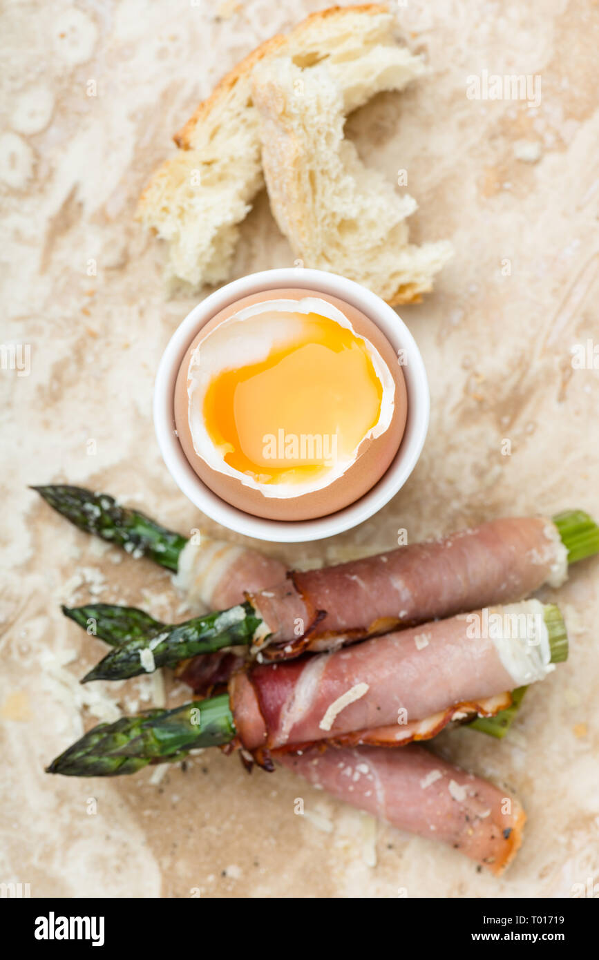breakfast with soft boiled egg and asparagus wrapped in Parma ham Stock Photo Alamy