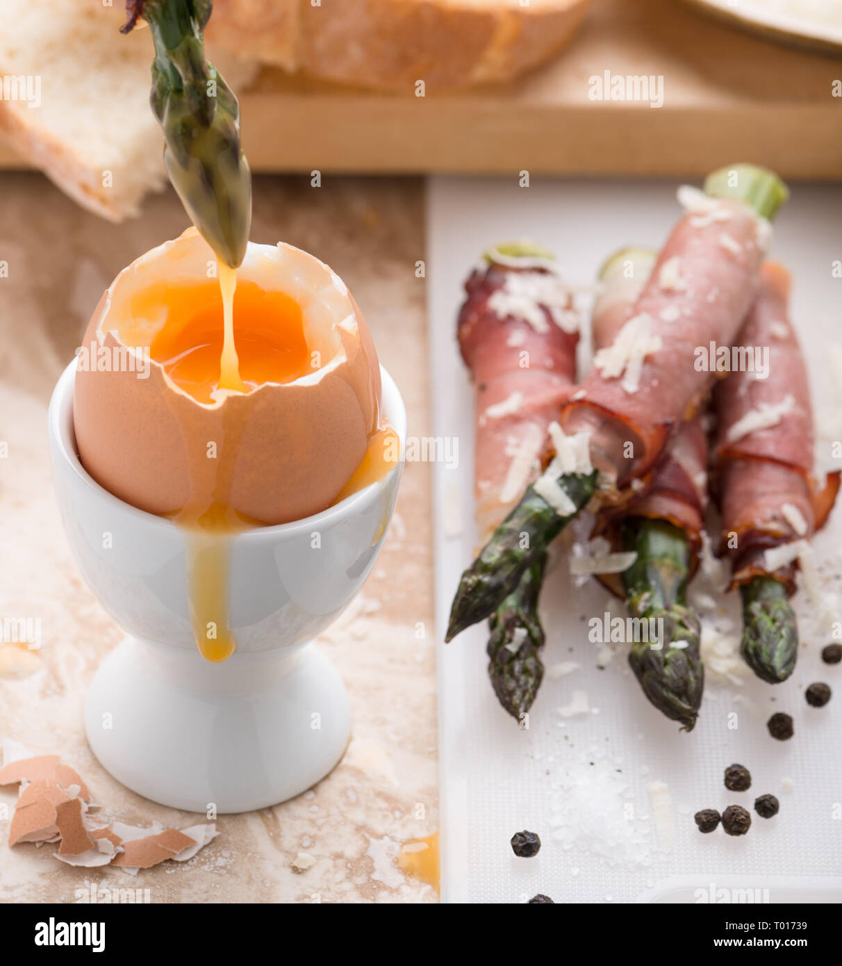 breakfast with soft boiled egg and asparagus wrapped in Parma ham Stock