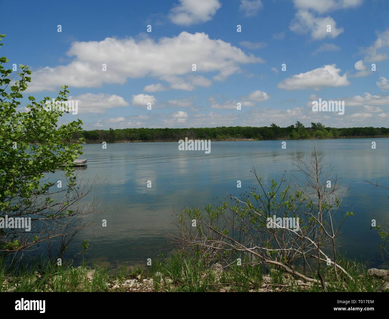 Blue and white skies reflected in the clear blue waters of Arbuckle