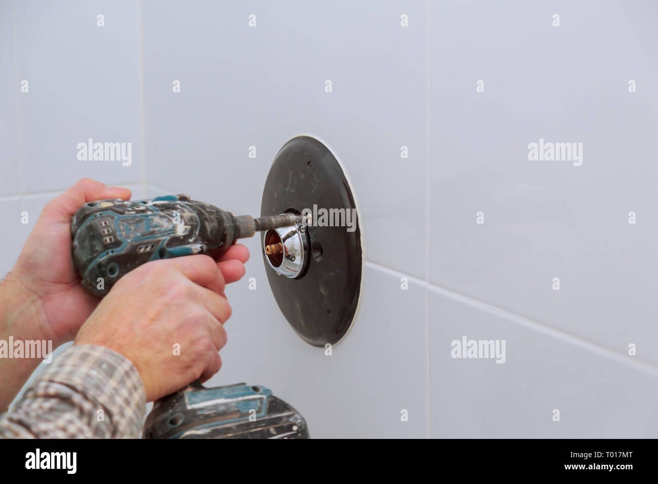 Installing a new on shower mixer tap in a bathroom in bath control heat