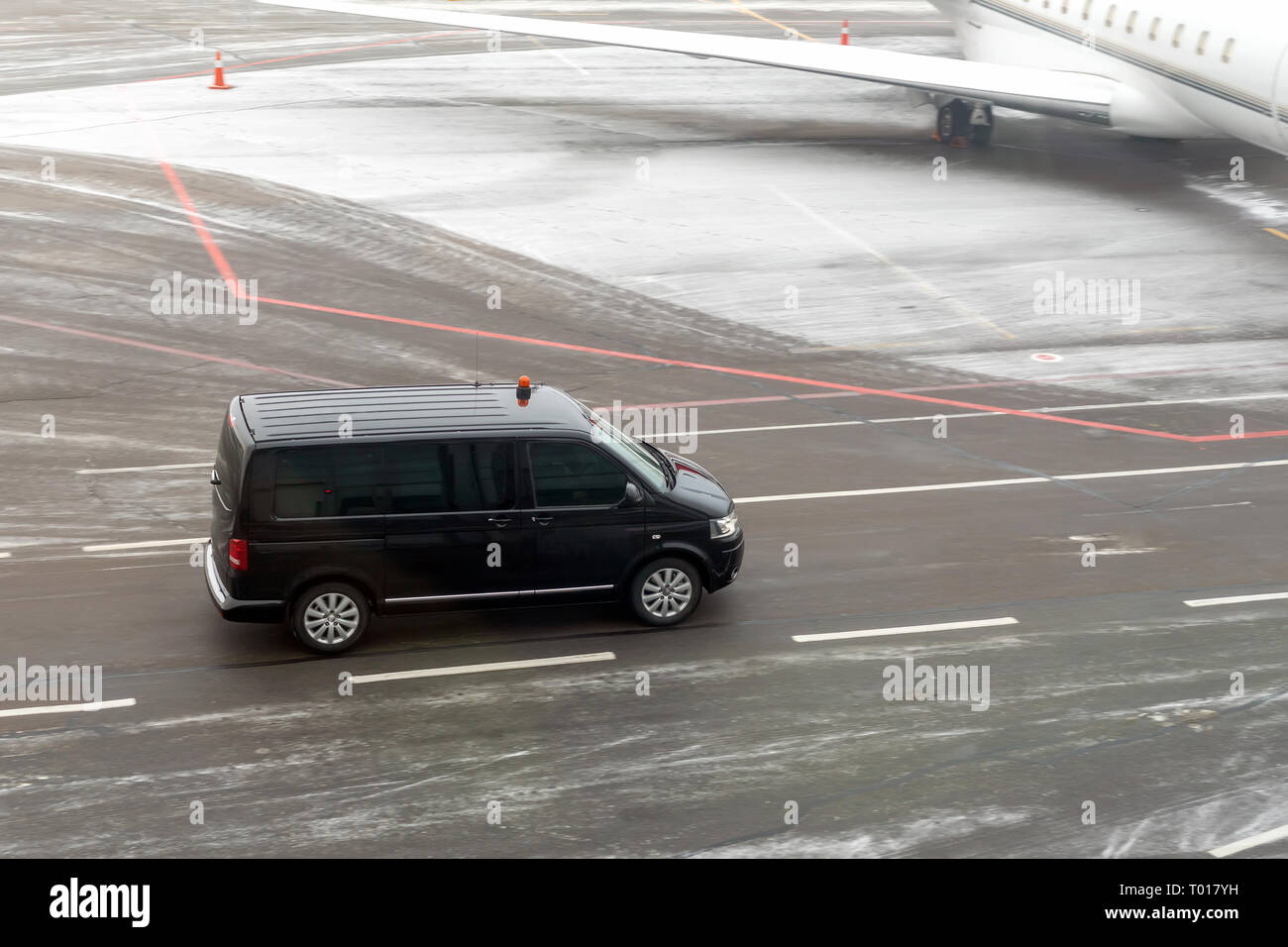 Black VIP service van running on airport taxiway with blurred private jet  on background. Business class service at airport. Security intelligence agen  Stock Photo - Alamy