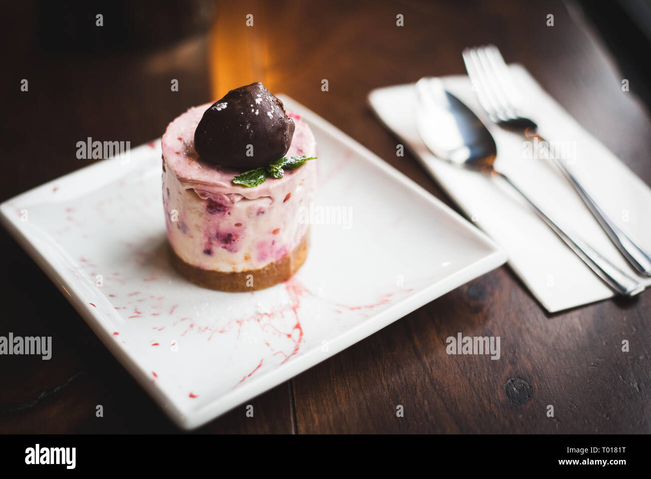 cherry cheesecake with scoop of chocolate on top Stock Photo Alamy
