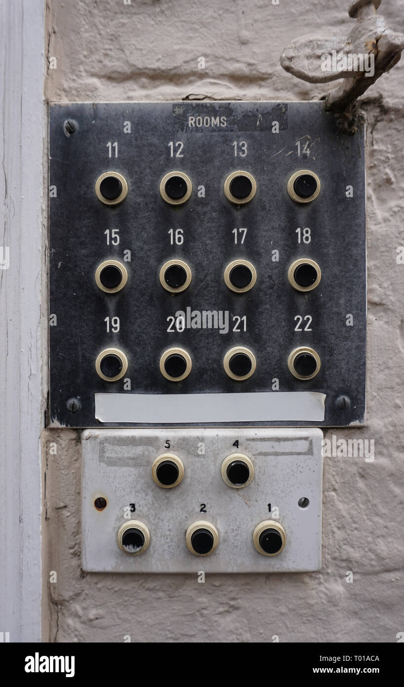 an old intercom or buzzer panel for multiple rooms, mounted on a brick wall Stock Photo