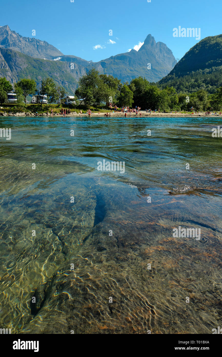 The clear mountain water of the Rauma River and Kalskråtinden mountain in the summer landscape of the Romsdalen Valley near Åndalsnes, Norway Stock Photo